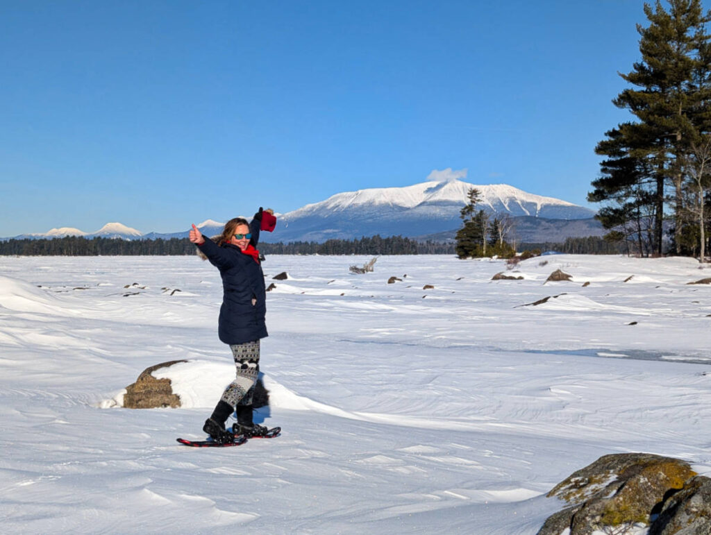 Kelly Snowshoeing with Snow Covered Katahdin from across frozen Millinocket Lake at NEOC New England Outdoor Center Maine 3
